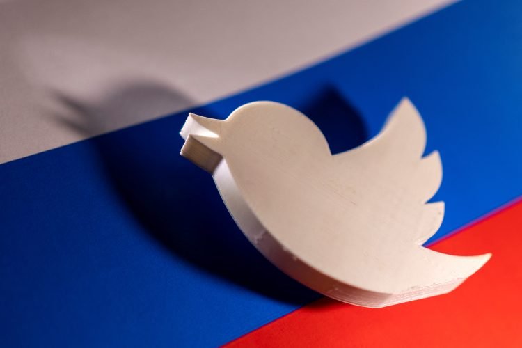 FILE PHOTO: Twitter logo is placed on a Russian flag in this illustration picture taken February 26, 2022. REUTERS/Dado Ruvic/Illustration